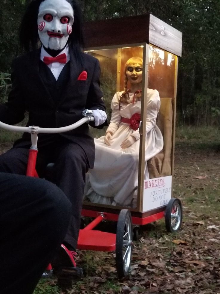 two people in costumes riding on a small cart