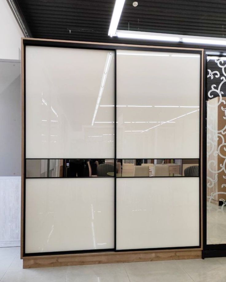 the sliding doors are white and brown with black trimmings on each one side