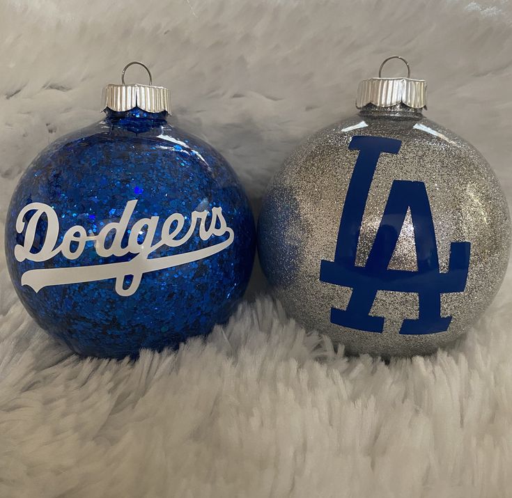 two christmas ornaments with the word dodgers painted on one ornament and the number 4 on the other