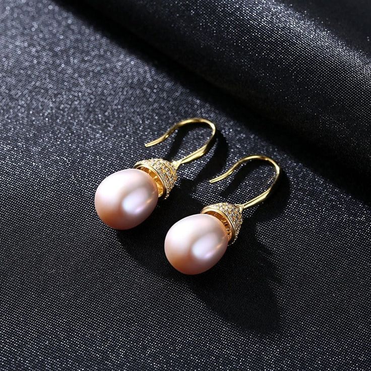 Enhance your natural glow with the right kind of luster, through the splendor of real pearl earrings. Less is definitely more when it comes to these dainty, yet utterly radiant white pearl drop earrings that capture the light from every angle. Measuring 10mm, the Freshwater pearl earrings are the ideal jewelry piece to compliment your wardrobe. our earrings come in fine settings: 14K yellow gold. * Buy over 2 pieces and get a medium jewelry organizer * Buy over $100 and get a large mirror jewelr Exquisite Pearl Earrings For Gifts, Elegant High Luster Pearl Earrings Gift, Pear-shaped High Luster Pearl Earrings, Pear-shaped High Luster Pearl Earrings Gift, Pearl White High Luster Pear Shaped Pearl Earrings, Akoya Pearl Drop Earrings Gift, Elegant High Luster Pearl Earrings, Elegant Pear Shaped Pearl Earrings For Gift, Elegant Round Pearl Earrings With High Luster