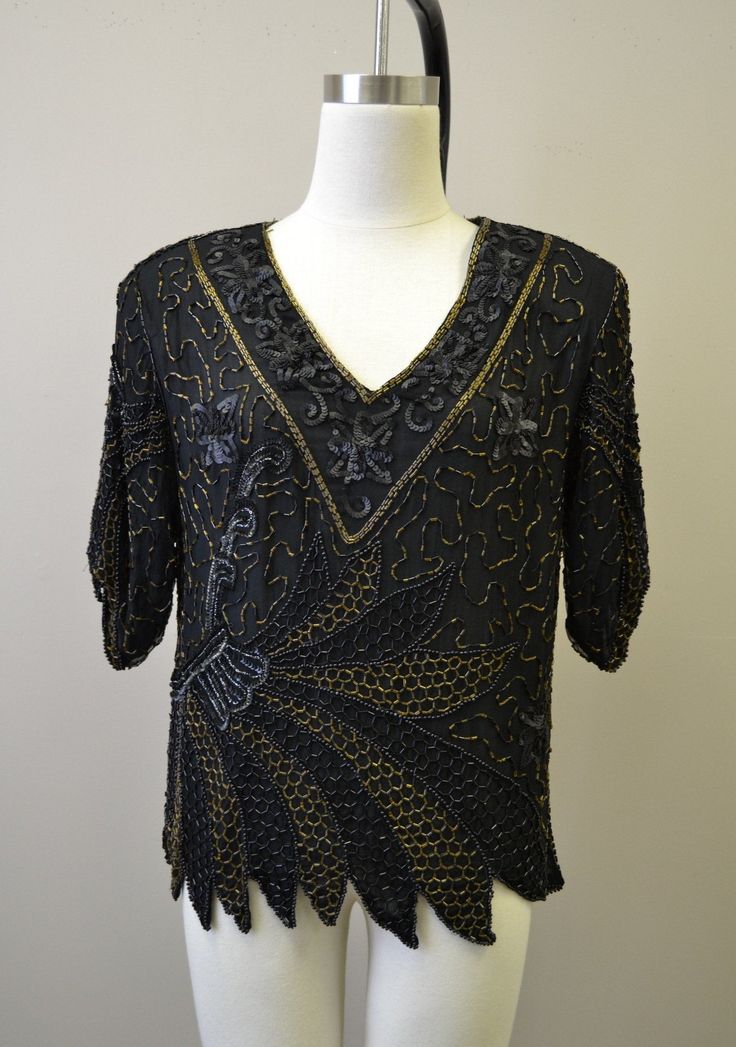 "Description: 1980s black sequin and bead blouse. Some of the sequins have a matte finish. Scalloped edge on hem and sleeve cuffs. Padded shoulders and a V-neck. Silk exterior with rayon lining. Made in India. Condition: In great condition, with no holes or stains. Designer: Mark and John II Stated Size: Large Measurements: Armpit to armpit: 20\" Shoulder to shoulder: 19\" Sleeve length: 14\" Overall length: 24\" Waist: 38\" ---> If you need an order shipped by a particular date or shipped vi Sequin Blouse, Beaded Blouse, Black Matte, Black Sequins, Scalloped Edge, Bodice, Vintage Outfits, Sequin, Blouses For Women