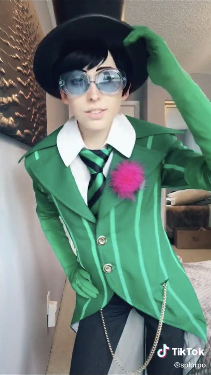 a person in a green suit and hat