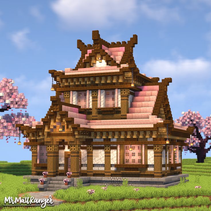 a large wooden house sitting on top of a lush green field