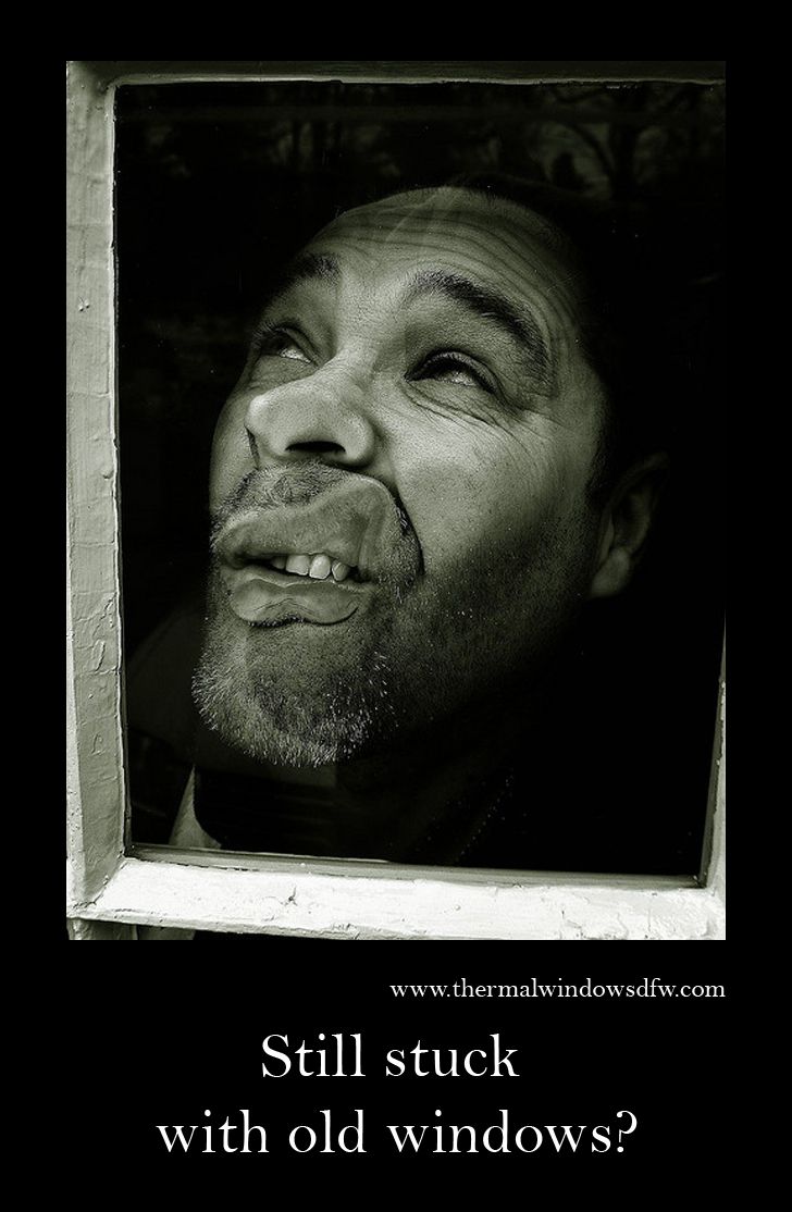 a black and white photo of a man looking out the window with his eyes closed