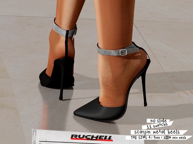 a woman's legs wearing high heels with silver straps