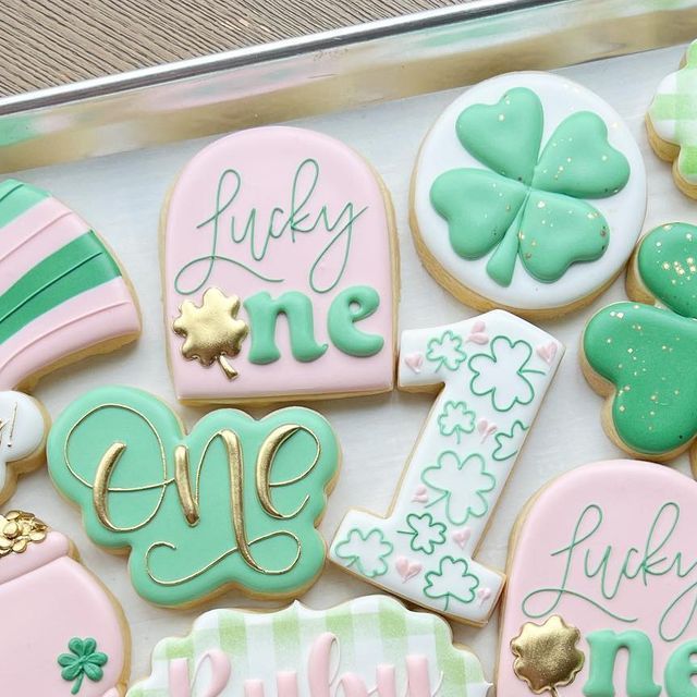 decorated cookies in the shape of shamrocks and st patrick's day decorations are on display