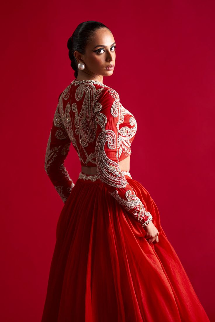 Editor's Note A serene traditonal look in this flowy skirt matched with hand embroidered pattern blouse. Fabric: Organza Color: Red Component: Skirt, blouse and dupatta Occasion: Engagement Car... Luxury Red Chanderi Blouse Piece, Luxury Blouse With Dupatta For Traditional Ceremonies, Luxury Traditional Blouse For Diwali, Luxury Red Blouse Piece With Sheer Dupatta, Luxury Blouse Piece With Intricate Embroidery For Diwali, Luxury Embroidered Blouse Piece For Diwali, Luxury Red Designer Wear Choli, Luxury Red Choli For Transitional Season, Luxury Red Choli For Diwali