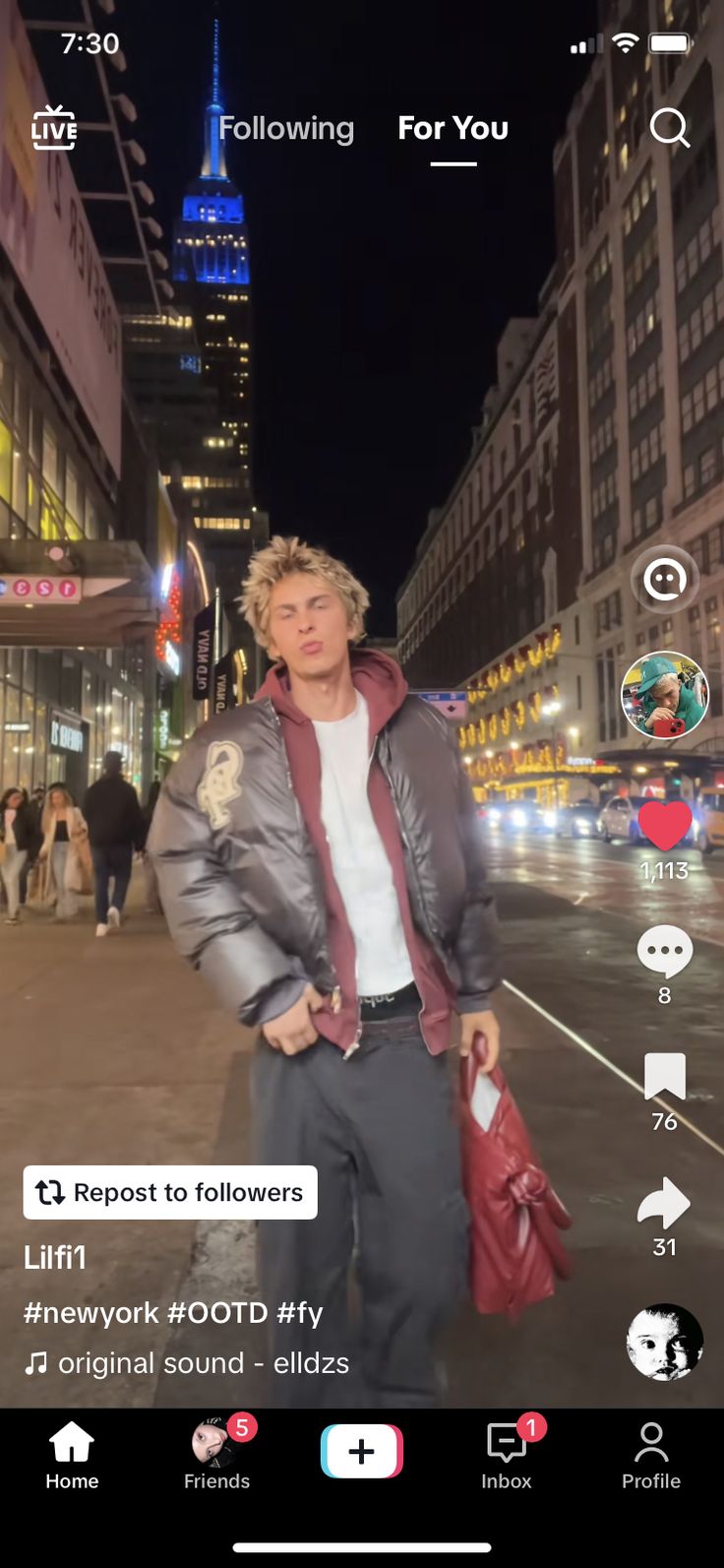 a man standing in the middle of a street at night with his hands in his pockets