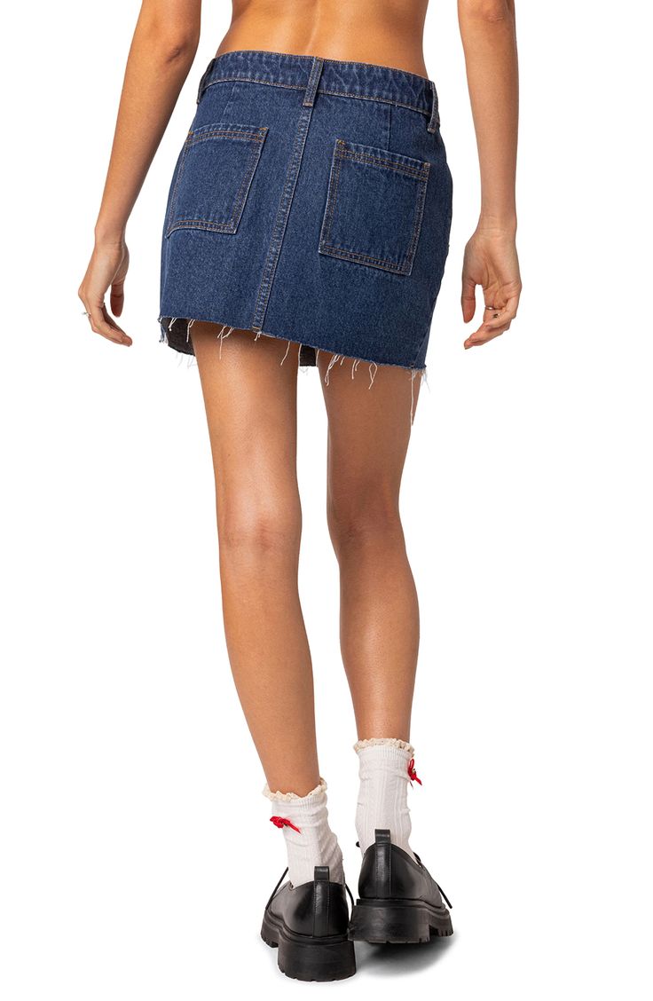 This cute miniskirt is made with nonstretch denim and designed with a raw hem for authentic vibes. Zip fly with button closure Coin pockets; front slant pockets; back patch pockets 100% cotton Machine wash, line dry Imported Trendy Mini Cotton Bottoms, Dark Wash Cotton Mini Skort, Dark Wash Cotton Mini Denim Skirt, Dark Wash Cotton Cutoff Skort, High Rise Cotton Skort With Frayed Hem, Trendy Denim Blue Cotton Skort, Frayed Hem Denim Mini Skirt For Summer, Trendy Dark Wash Cutoff Skort, Summer Denim Mini Skirt With Frayed Hem