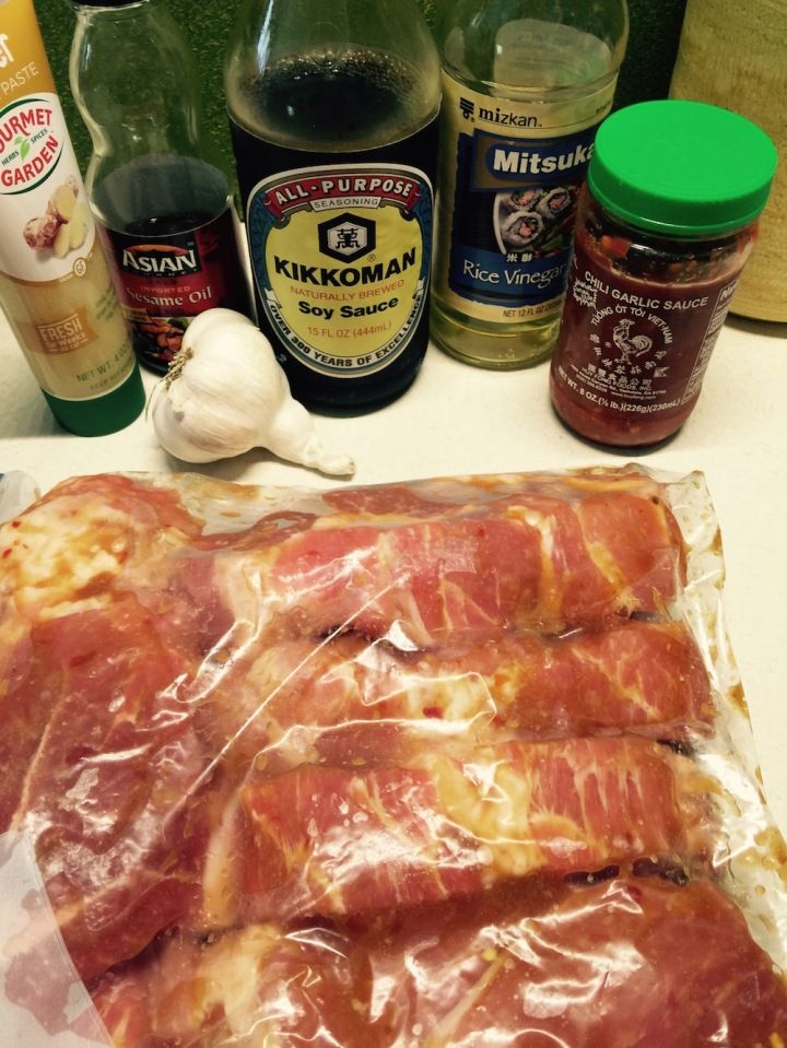 bacon wrapped in plastic sitting on top of a counter next to spices and condiments