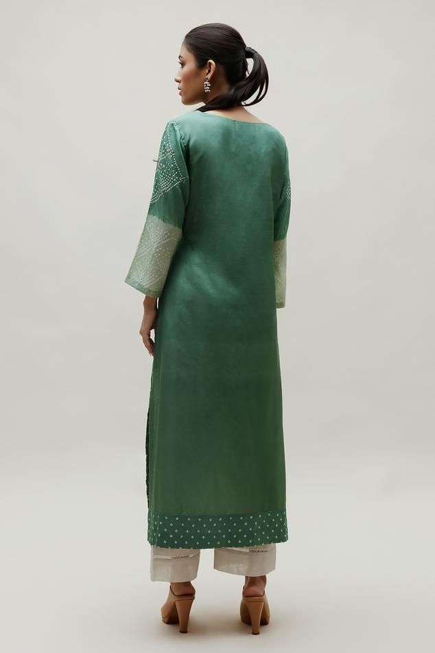 Green silk straight kurta with all over bandhani pattern, accentuated with an embroidered yoke in gota patti work.
Components: 1
Pattern: Woven, Embroidery
Type Of Work: Bandhani, Gota Patti
Neckline: Round Neck
Sleeve Type: Full Sleeves
Fabric: Silk
Color: Green
Other Details: 
Length: 48 inches
Note: Pant worn by the model is not for sale

Occasion: Puja - Aza Fashions Bandhani Pattern, Woven Embroidery, Kurta Women, Gota Patti Work, Straight Kurta, Fabric Silk, Green Silk, Full Sleeves, Embroidered Silk