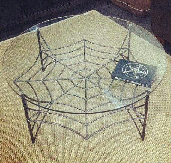 a glass table with a spider web design on it