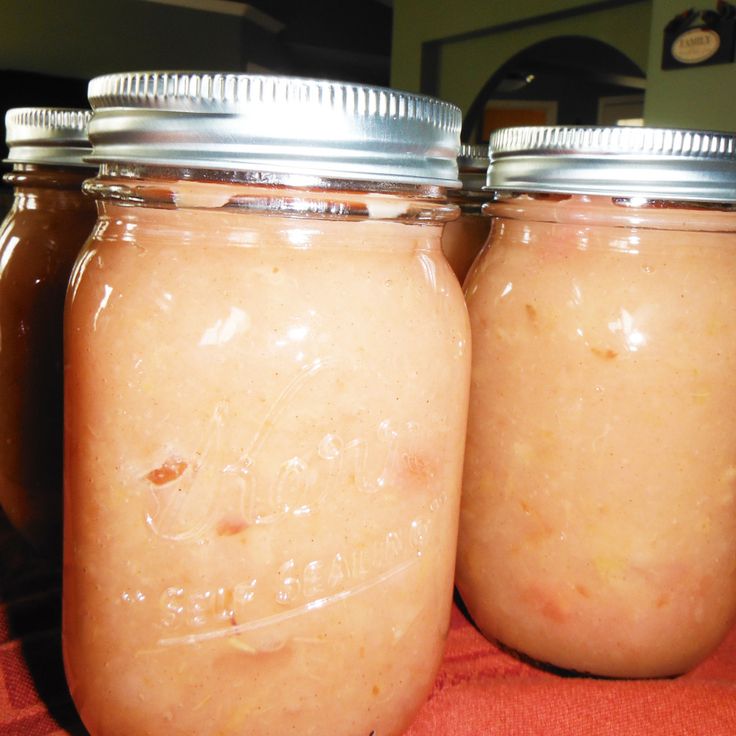 three jars filled with liquid sitting on top of a table