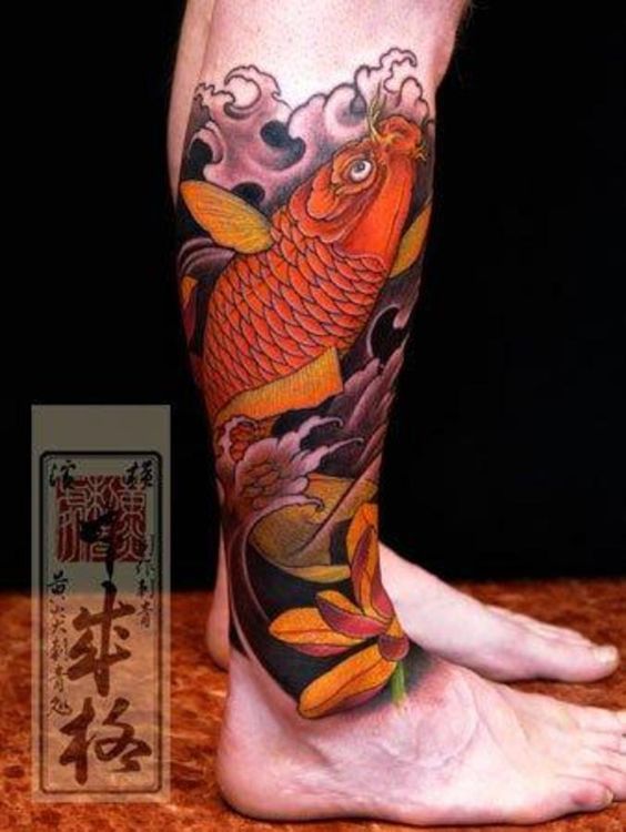 a man's leg with a fish tattoo on it