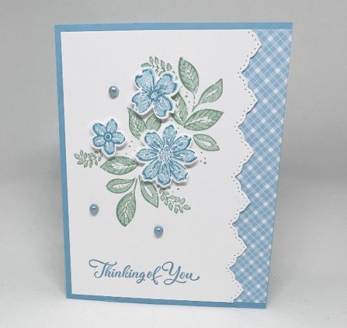 a blue and white card with flowers on it