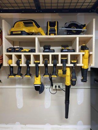 there are many tools on the shelves in this room, including drillers and screwdrivers