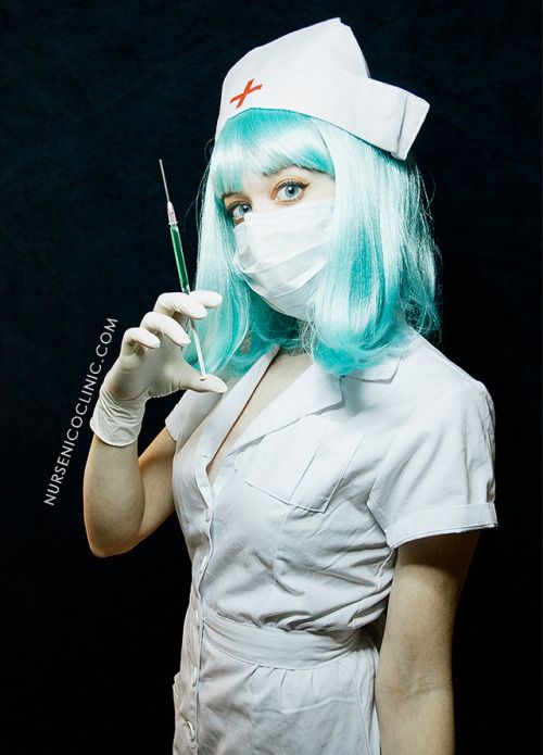 a woman with green hair wearing a white nurse outfit and holding a syringe