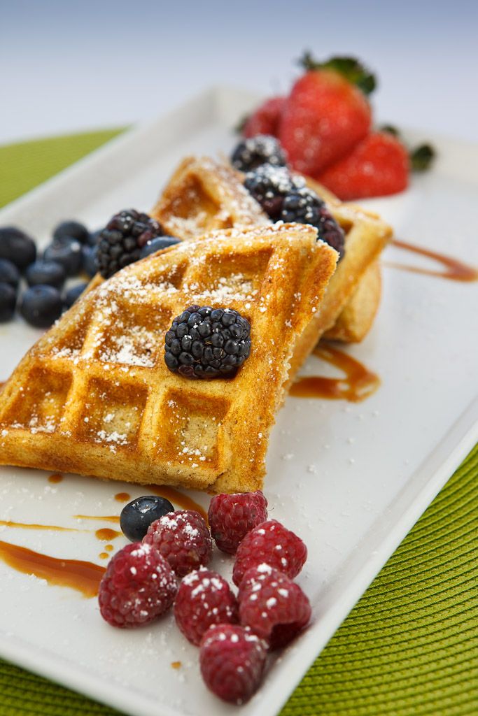 waffles with berries and syrup on a plate