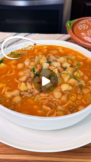 a white bowl filled with soup on top of a wooden table