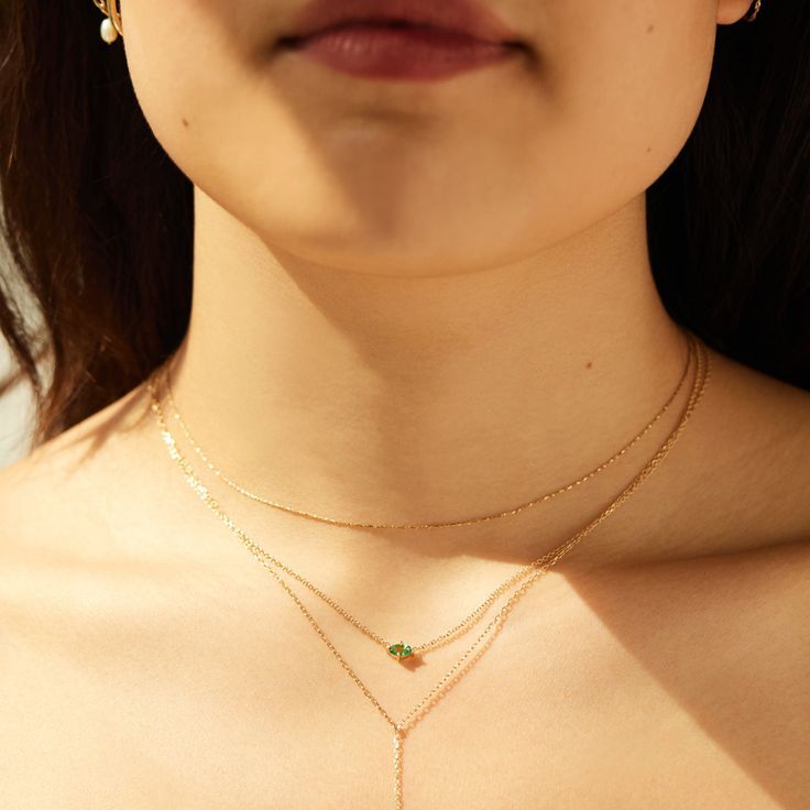 Draped around a woman's neck are three golden necklaces. The middle one is a thing gold chain with a horizontal emerald in a glowing green. Catbird Jewelry, Portrait Necklace, Yellow Gold Chain, Recycled Gold, Engagement Ring Wedding Band, Gifts For Wedding Party, Beauty Shop, Wedding Ring Bands, Gold Chain