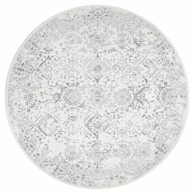 a round rug with white and silver designs