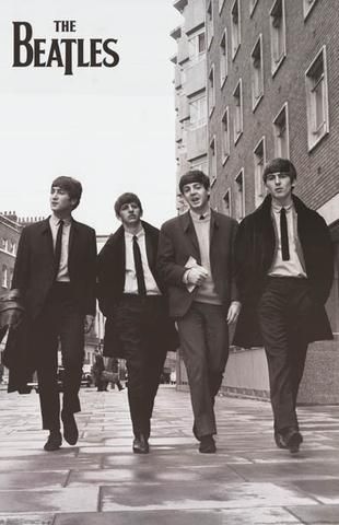 four men in suits walking down the street with one man wearing a suit and tie