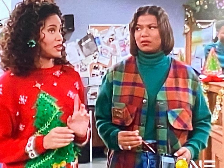 two women standing next to each other wearing christmas sweaters