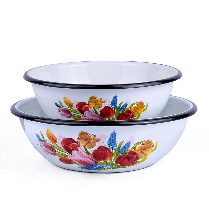 two bowls with flowers painted on them sitting side by side in front of a white background