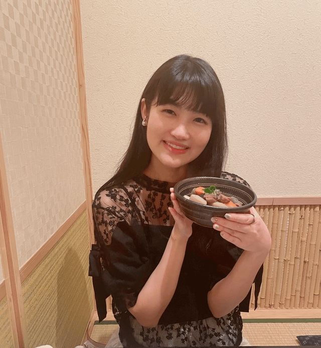 a woman holding a plate with food on it