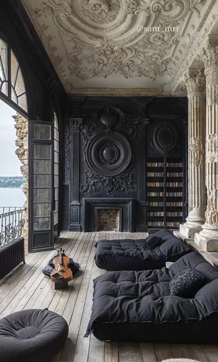 an ornate room with black and white walls, wooden floors and floor to ceiling windows