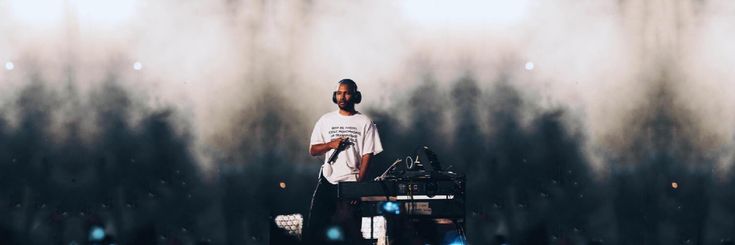 a man standing in front of a dj mixer