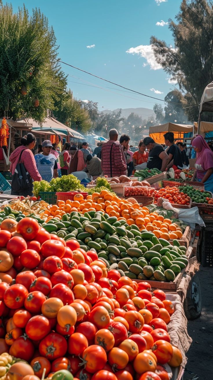 an open air market with lots of fresh fruits and vegetables for sale on the tables