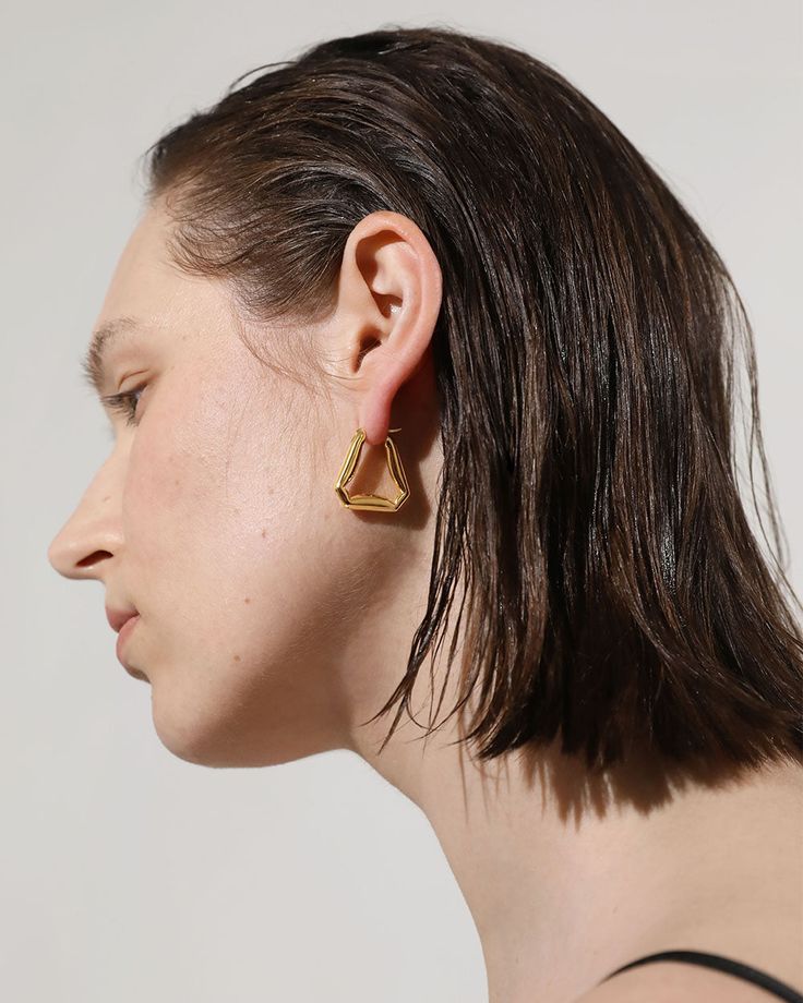 A confident style never goes unnoticed–allow your personality to shine through with these folded triangle hoop earrings, an ode to those who love retro-geometric shapes and artistic creativity. A subversive-basic design blended with wearability gives these hoops endless possibilities.

Size: 24x24mm
Material: 18k Gold Plated On Brass Gold Geometric Earrings For Everyday, Modern Triangle Gold Hoop Earrings, Gold Triangle Minimalist Earrings, Minimalist Gold Triangle Earrings, Trendy Gold Triangle Earrings, Everyday Gold Triangle Earrings, Geometric Gold Hoop Earrings For Everyday, Minimalist Triangle Earrings For Everyday, Gold Geometric Hoop Earrings For Everyday