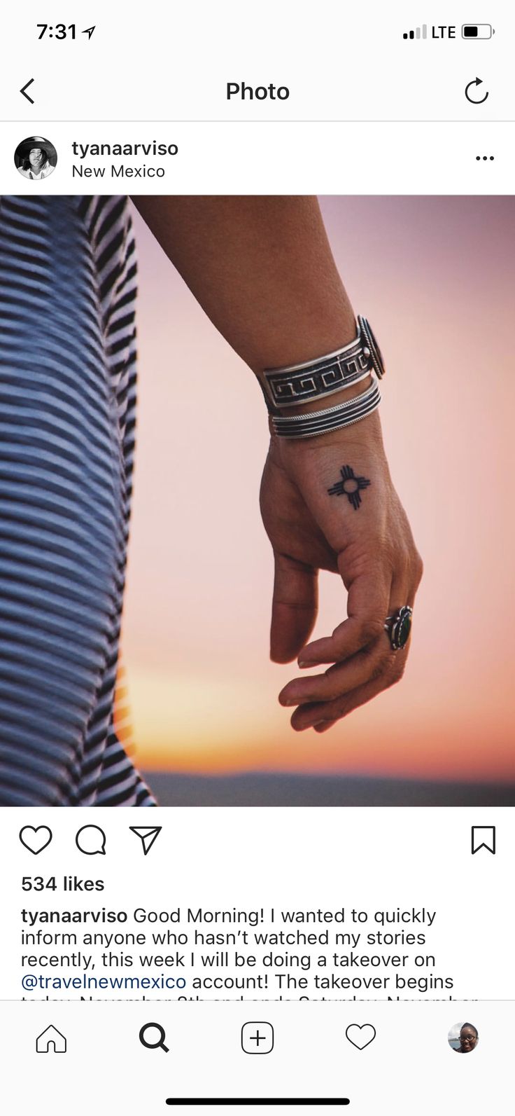 two people holding hands with tattoos on them