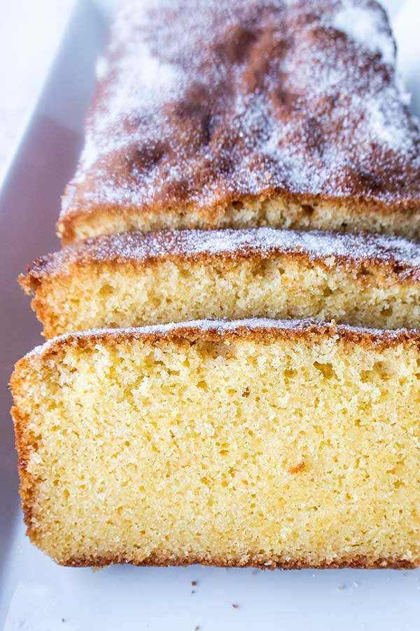 two slices of cake sitting on top of a white plate with powdered sugar toppings