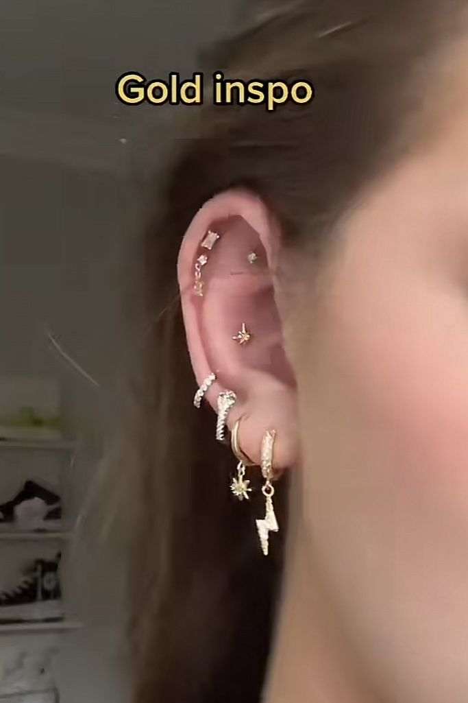 a woman wearing ear piercings with stars on them