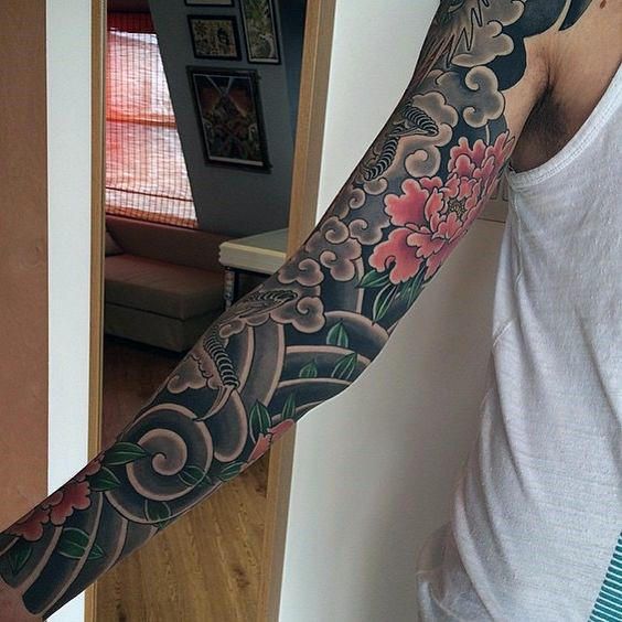 a man with a tattoo on his arm