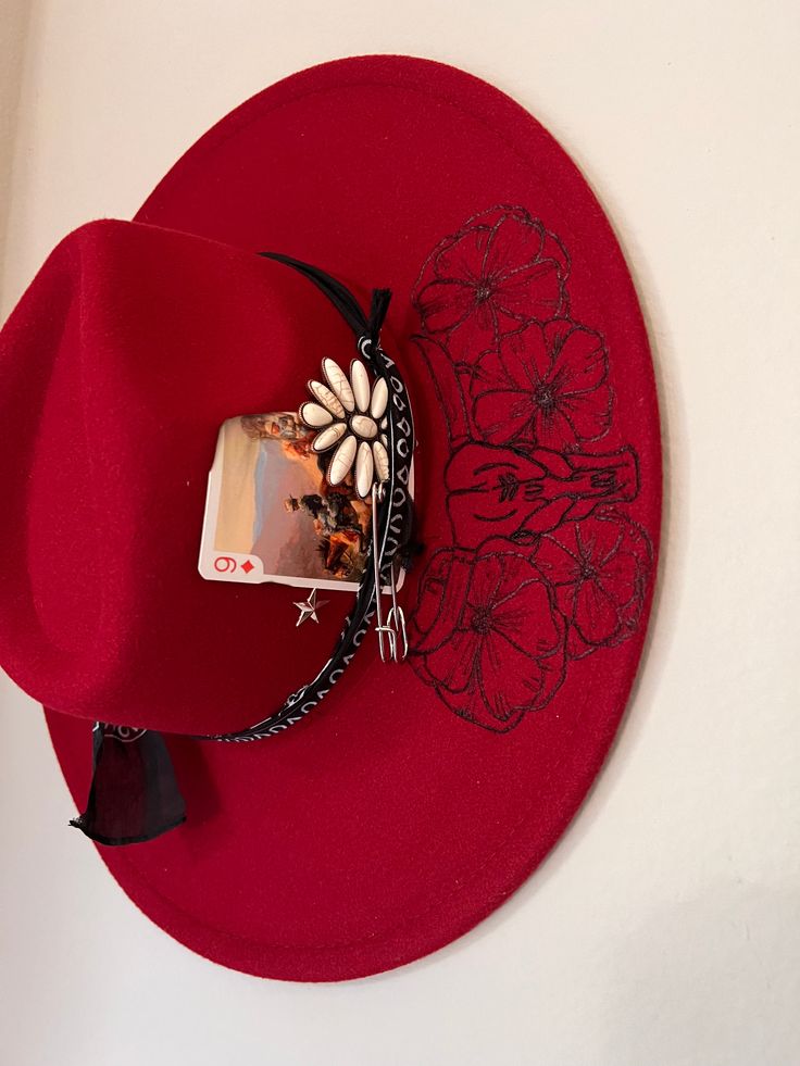 Be the life of the rodeo in this gorgeous boho red hat featuring a bull, poppies, and playful longhorns. Add this accessory to your wardrobe for a unique western touch. Adjustable Red Hat Bands For Spring, Adjustable Red Hat Bands For Kentucky Derby, Bohemian Fedora For Kentucky Derby And Rodeo, Adjustable Red Festival Hat, Red Western Fedora For Kentucky Derby, Unique Adjustable Fedora For Rodeo, Red Hats For Country Events In Summer, Red Hats For Spring Gifts, Red Brimmed Hat For Festival