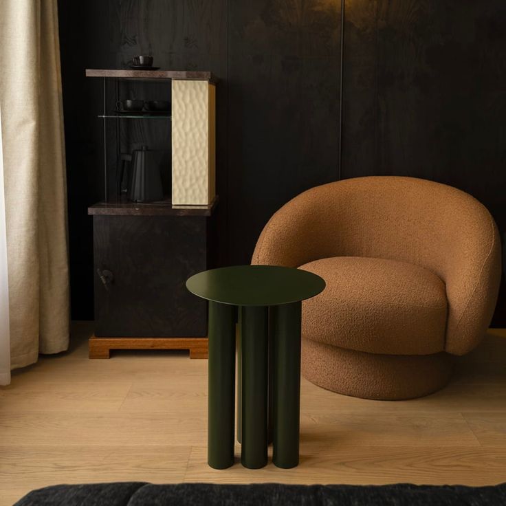 a chair and table in a room with black walls