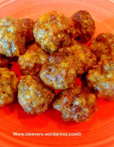 some meatballs are sitting on a red plate and ready to be eaten by someone