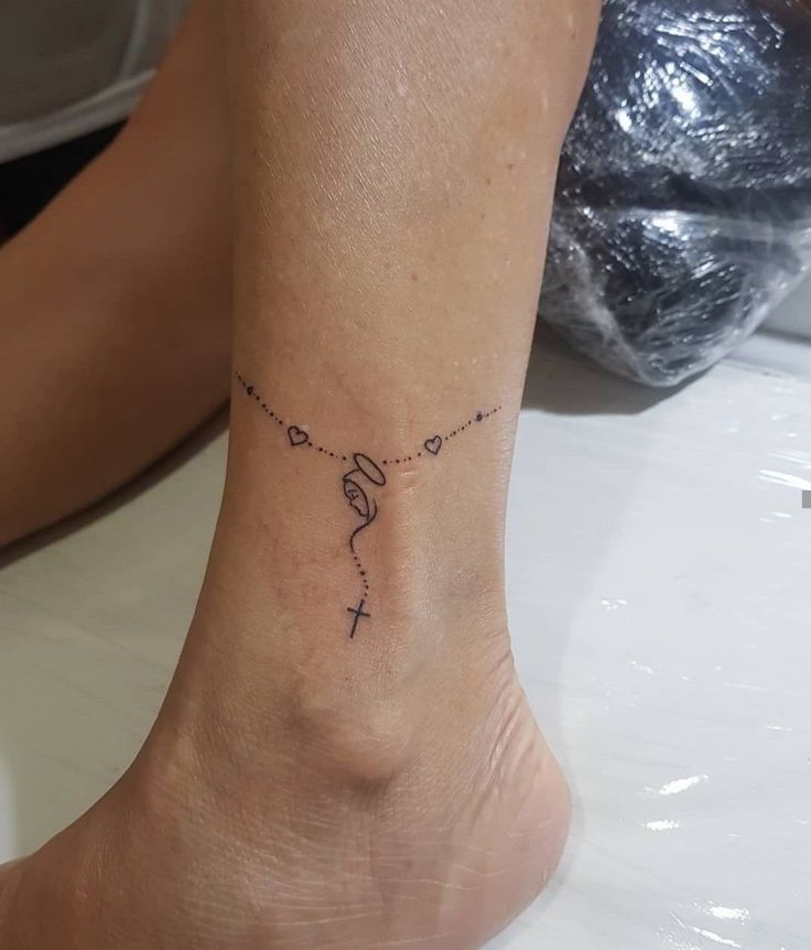 a woman's foot with a small tattoo on the ankle that reads, love