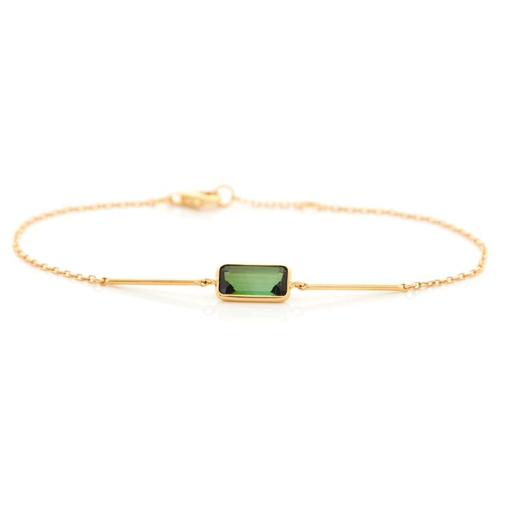 Tourmaline is known to occur in nature with excellent vibrancy of color and this bracelet is an excellent example.  Two gold bars flank the central green gem to emphasize its beauty. This is a handmade treasure.  This unique design is perfect for the modern woman. A modern classic that can be worn everyday.  Hand forge Elegant Gold Tourmaline Bracelets, Elegant Tourmaline Jewelry For May Birthstone, Modern Green Gemstone Bracelets, Modern Yellow Gold Tourmaline Jewelry, Elegant Green Gemstone Gold Bracelet, Modern Green Tourmaline Jewelry, Modern Gold Tourmaline Jewelry, Elegant Tourmaline Bracelets As Gift, Elegant Tourmaline Bracelets For Gift