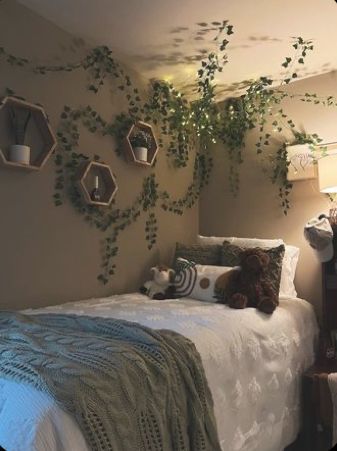 a bed room with a neatly made bed and hanging plants on the wall above it