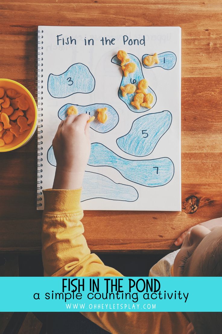 a child is drawing fish in the pond on a piece of paper that says fish in the pond