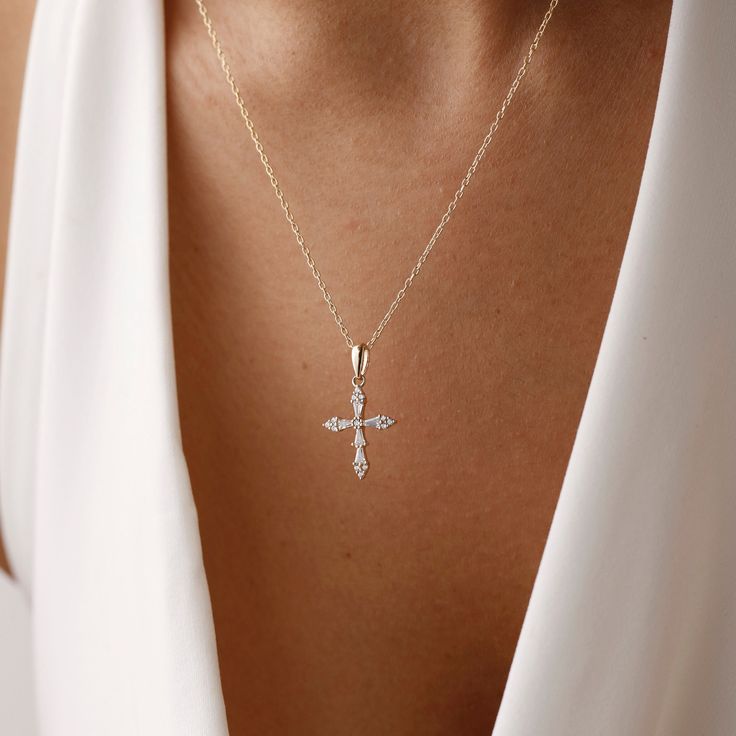 Add dainty to your combinations with our elegant Cross Necklace. Crafted with precision and care, this necklace features a delicate cross pendant adorned with sparkling pave crystals. The elegant design adds a subtle yet stylish accent to any outfit, making it perfect for everyday wear or special occasions. Made from high-quality materials, including durable metal and sparkling crystals, this necklace is designed to last. Its adjustable chain ensures a comfortable fit for everyone, while its tim Wedding Jewelry With Cross Pendant, Elegant Cross Necklace With Adjustable Chain, Elegant Personalized Cross Jewelry, Elegant Personalized Cross Necklace, Elegant Personalized Crucifix Necklace, Personalized Elegant Crucifix Cross Necklace, Personalized Elegant Cross Necklace, Minimalist Cross Pendant Necklace For First Communion, Elegant Personalized Cross Pendant Jewelry