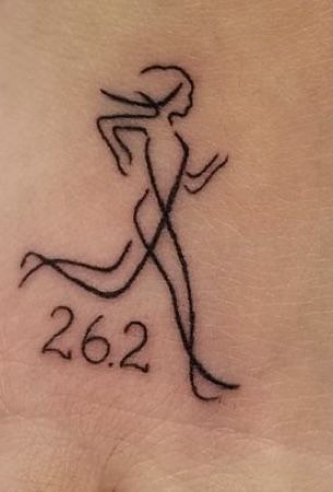 a woman's foot with a tattoo on it that reads 2052 and the number twenty