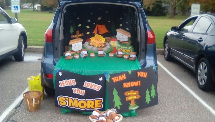 the back end of a van with some food on it in a parking lot next to parked cars