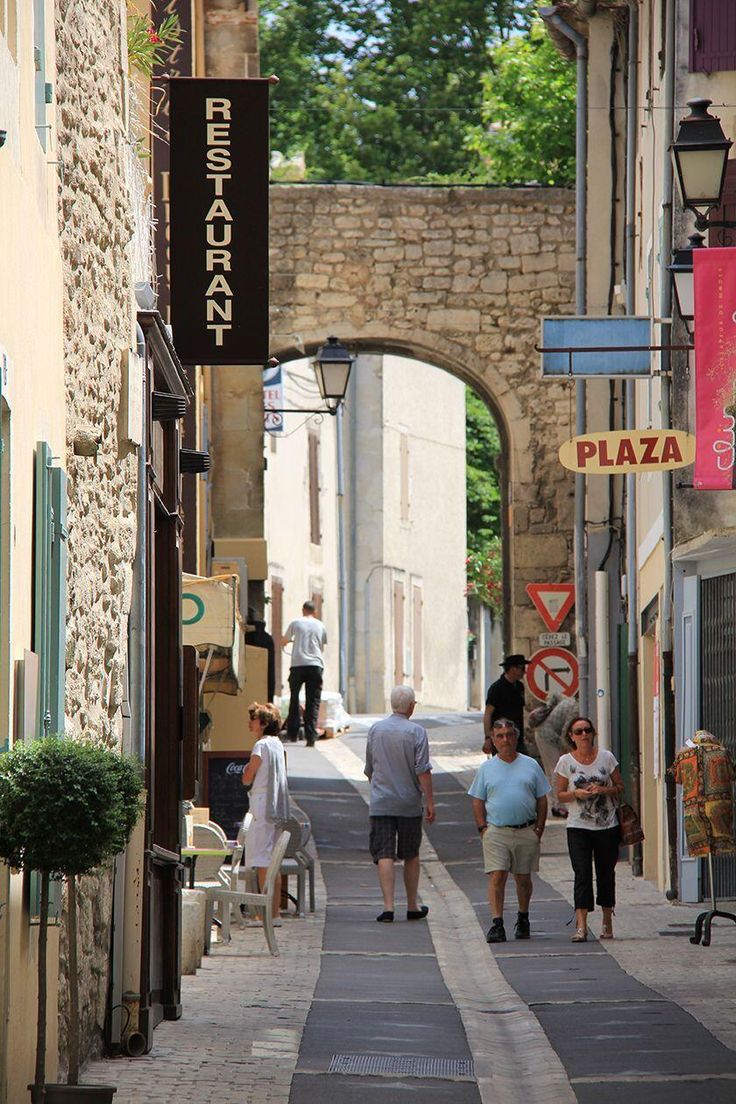 people walking down an alley way in the city