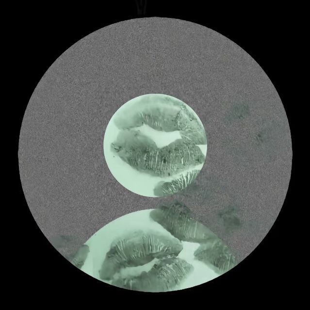 an image of two circular objects with green and black highlights in the middle one is round