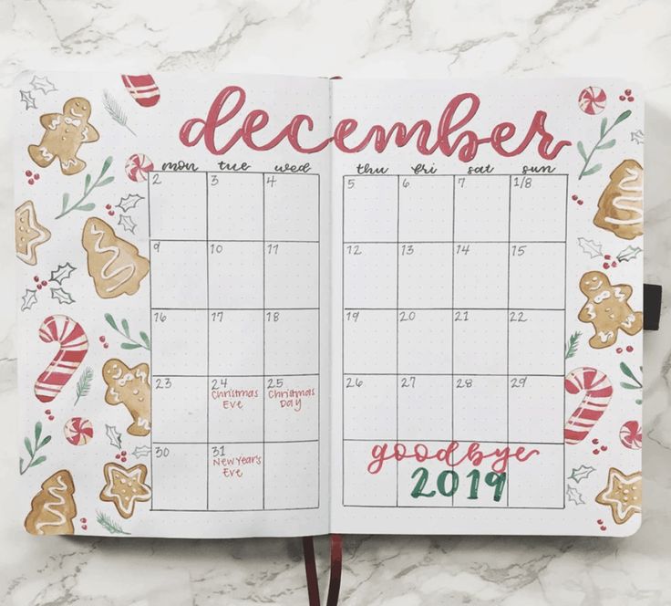 an open planner with the word december written in red and gold on top of it